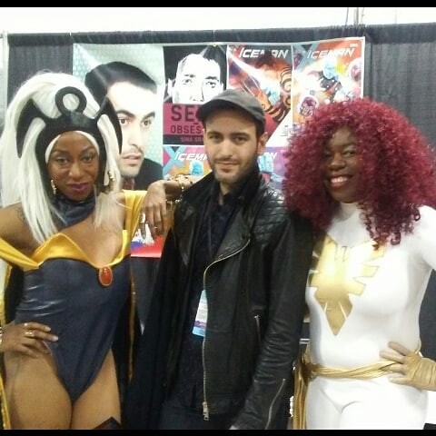 A Storm cosplayer next to comic book writer and artist Sina Grace and Jay in her White Phoenix of the Crown costume.