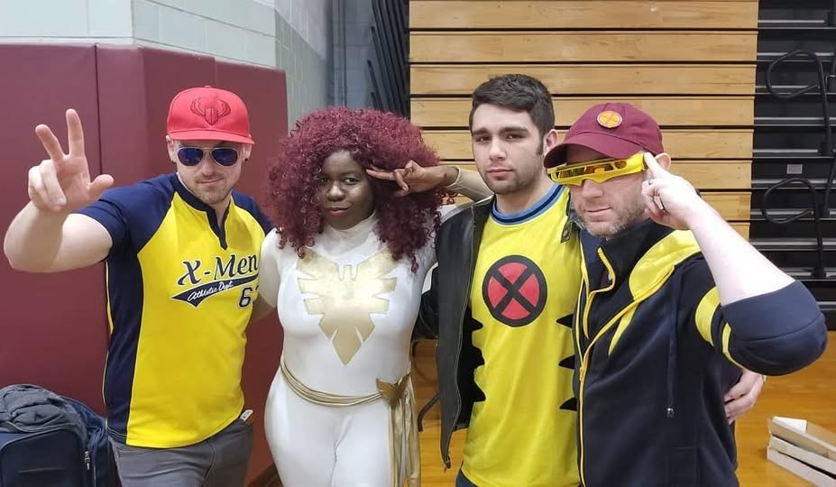 group photo of a bunch of adorable X-men nerds in casual Wolverine and Cyclops styled outfits, and Jay in her White Phoenix of the Crown costume